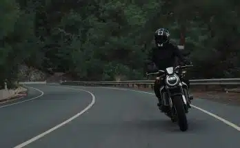 man riding motorcycle on concrete street