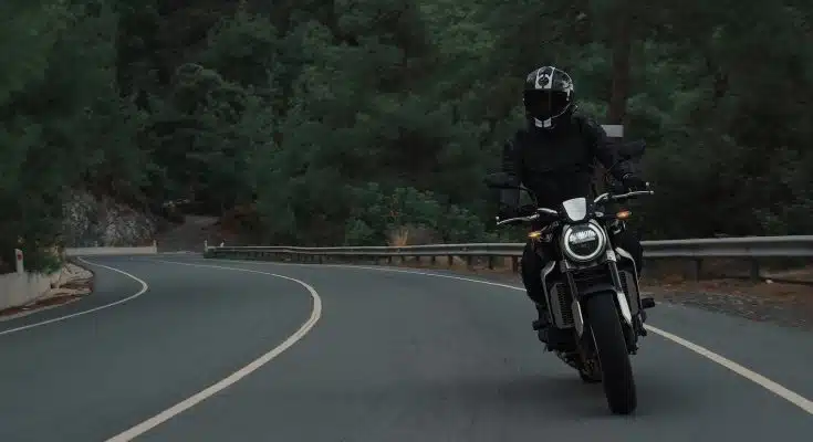 man riding motorcycle on concrete street